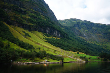 Fototapeta premium Amazing nature view with fjord and mountains. Beautiful reflection. Picturesque landscape mountains of Norway. Travelling, lifestyle, wild nature concept.