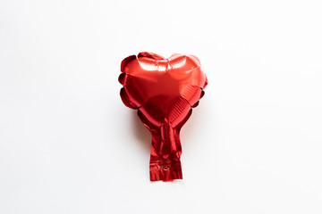 Red foil ballon heart on a white background - valentines day card