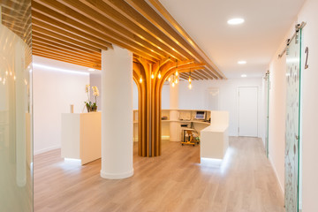Reception of modern office with lights and wood on the ceiling