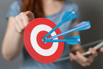 hand holding a target with darts hitting the center over white background. Concept of .