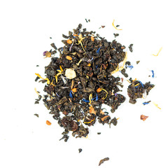 pile of natural green tea mix contains petals and leaves of strawberries, roses, sunflowers and cornflower