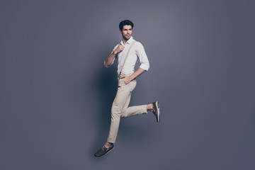 Full length profile side photo of gorgeous elegant man jump walk want attract woman adjust button...
