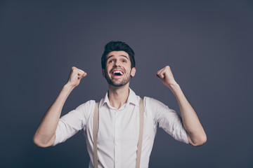 Naklejka premium Omg I millionaire. Excited rejoice specialist professional man achieve aims feel ecstatic emotion scream yeah raise fists look up copyspace wear modern outfit isolated grey color background