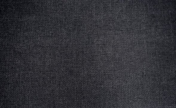 Dunkelgrau schwarze Stofftextur als Hintergrund