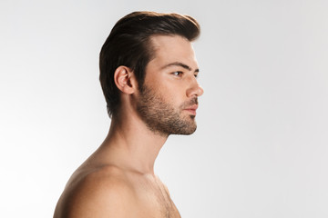 Obraz premium Photo of unshaven half-naked man posing and looking aside