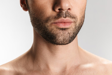 Obraz premium Cropped photo of unshaven half-naked man posing at camera