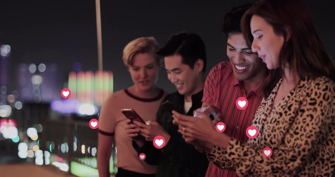 Group Of Millennials Using Smart Phone At Night On Roof With Animation Of Likes Button On Social Media