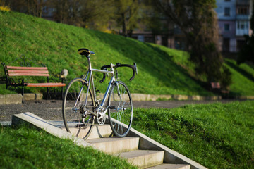 Fototapeta premium Vintage hybrid bicycle parking against street.