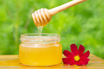 Honey in glass jars with flowers