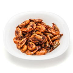 shrimp fried in soy sauce on a white plate isolate