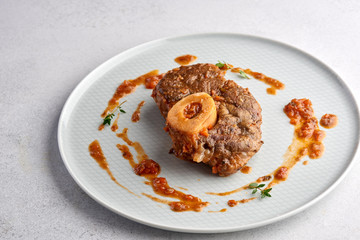 Tempura prawn served on rectangular white plate on dark gray stone background