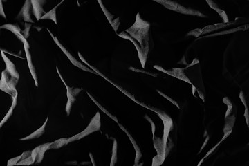 Crumpled cloth in black, Light causes patterns.