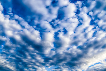 Beautiful view on white fluffy clouds in a deep blue sky