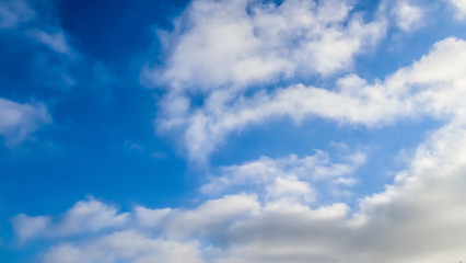 Beautiful view on white fluffy clouds in a deep blue sky