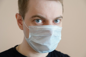 Young man wearing protective medical mask. Selective focus.