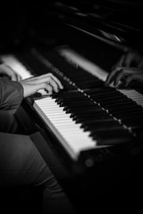 Fototapeta na wymiar Man's hands on piano keys – Black and White