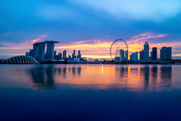 Singapore landmark city skyline at the Marina bay during sunset dusk.