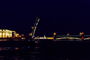 Fototapeta na wymiar Opening of Trinity drawbridge. Night view of Trinity bridge from the Neva river in St. Petersburg, Russia