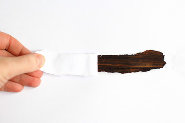 Hand tear a strip of white paper