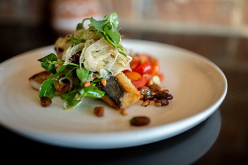 Grilled mackerel with tomatoes, capers and raisins