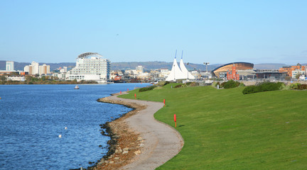 Path leading towards a panoramic view of Cardiff city along the waters edge