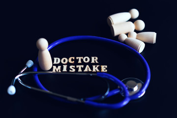 doctoral mistake concept. The inscription mistake and a stethoscope on a black background. Doctoral Mortality. toned
