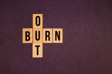 Burnout Word Written In Wooden blocks. Burn out, cubes with letters. dice with text. concept of the destruction of shortcomings, fears, burnout at work, daily routine. medical or health care concept 