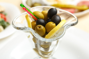 Green and black olives in a glass Cup