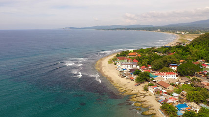 Coastal town with a surfer beach. San Juan, La Union, Philippines. Beach with hotels for tourists,...