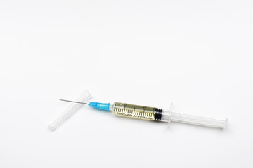Fototapeta premium close-up of a syringe with an injection and a cap on an isolated white background.