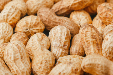 Background from golden peanuts in the shells