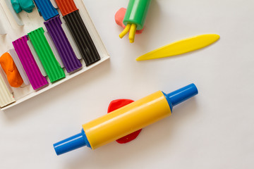 plasticine. dough for modeling. leisure and creativity for children. Concept of children's activities. Top view of multi-colored clay and tools for needlework.