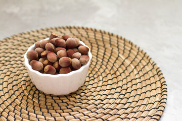 hazelnut in a white plate on a wooden background. full of nuts. the concept of proper nutrition and health, vitamins. the view from the top, place for your text. health food.