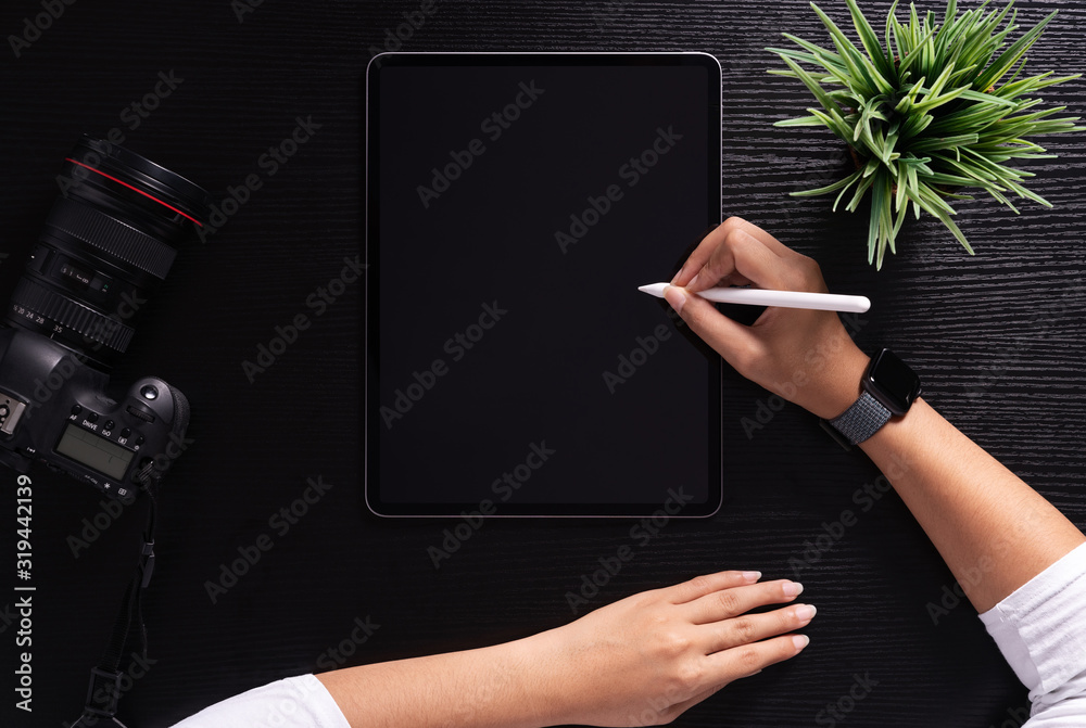 Poster designer using stylus pen on top view