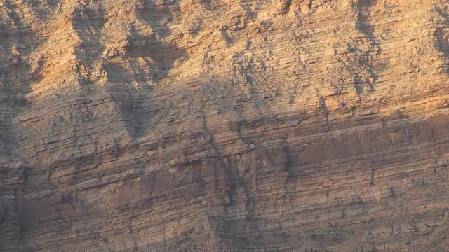 Sunlights on mountain canyon, Stone texture on a mountain face in early morning light, sedimentary mountain limestone rocks texture