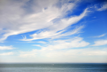 Naklejka na ściany i meble Scenic view of depp blue sea with cloudy sky