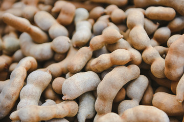 Pile of sweet tamarind for sale in the market fruit - fresh tamarind texture background