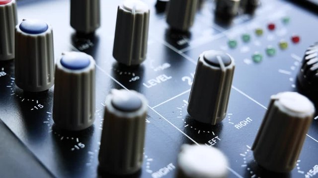EQ Bass and balance settings on analogue audio mixer. Close up 4k