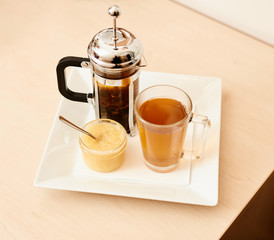 Tea with a teapot, cup and lemon jam. Natural fruit tea.