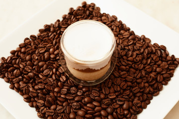 A cup of coffee in coffee beans. Coffee background