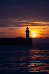Beautiful seascape with lighthouse on sunrise. Yalta lighthouse on the Black Sea. Crimea