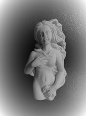 Photo of antique beautiful nude female sculpture on black surface