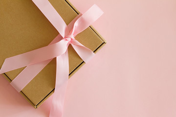gift box with pink bow on pink background. Gift for birthday, Valentine's Day, Christmas, New year, mother's Day, women's day. Gift for people. space for text. banner. postcard.
