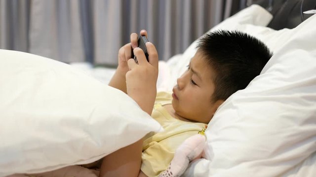 asian chinese children playing smartphone