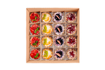 Collection of take away kraft box with delicious desserts with chocolate,raspberry,strawberry.