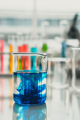 Testing some liquid in the laboratory glassware. Science, lab and medical concept.