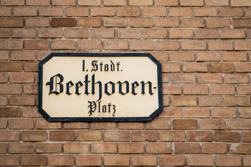 Fototapeta na wymiar Street sign of Beethovenplatz on a brick building in Vienna