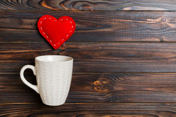 Top view composition of hearts splashing out from a cup on wooden background. Love and romance concept. Valentine's Day