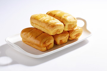 Homemade fluffy bread and biscuits on a white background