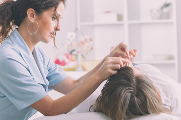 Obraz na płótnie Canvas Therapist applying acupuncture needle
